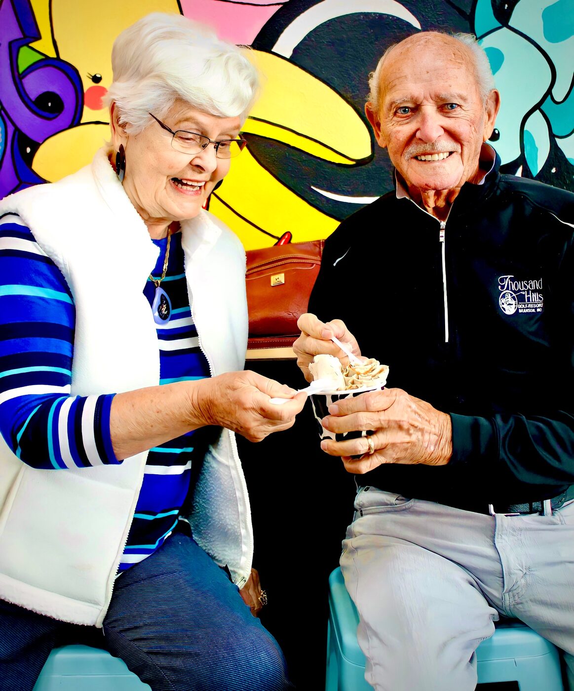A smiling couple sharing rolled ice cream at YOLO in Branson, MO